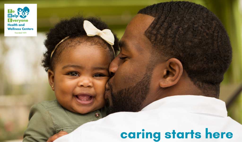 baby girl with bow in her hair being kissed by her dad with the tagline "caring starts here" and a company logo on the page